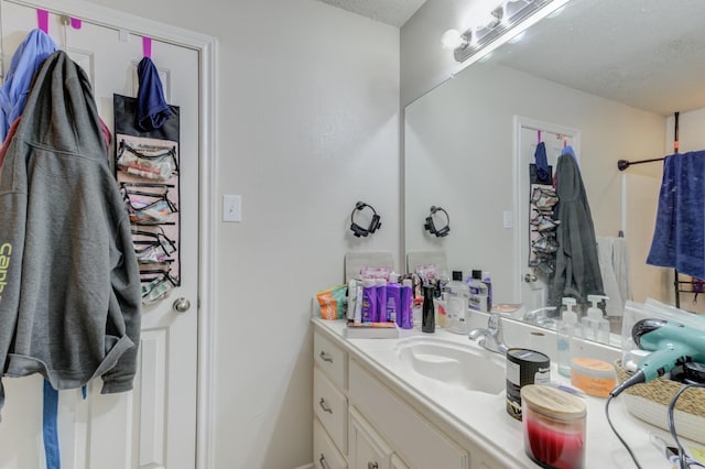 bathroom with vanity and a textured ceiling