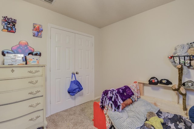 bedroom with light carpet and a closet