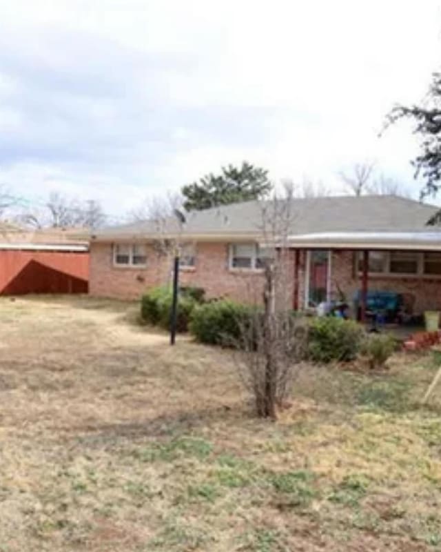 rear view of house with a lawn