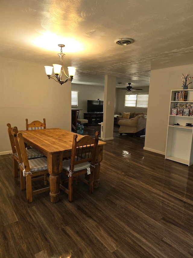 dining room featuring dark hardwood / wood-style floors and ceiling fan with notable chandelier