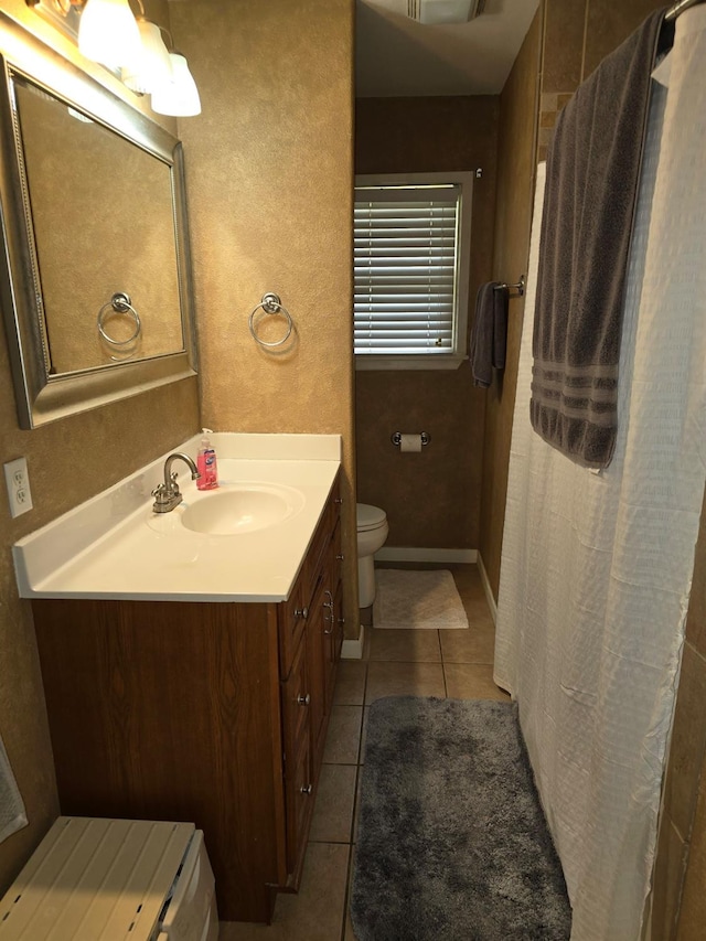 bathroom featuring tile patterned flooring, vanity, and toilet