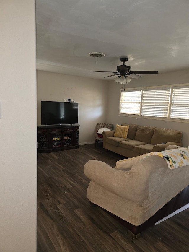 living room with dark hardwood / wood-style flooring and ceiling fan