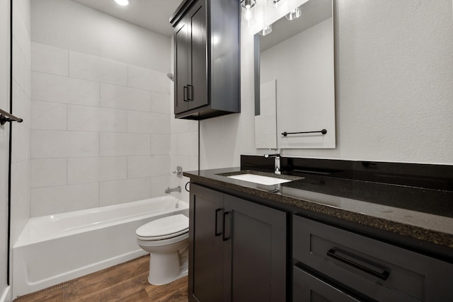 7814 96th St, Lubbock, TX 79424 - bathroom featuring toilet, vanity, wood finished floors, and tub / shower combination