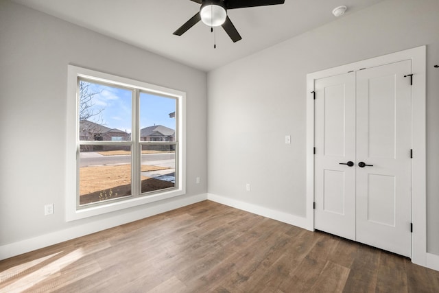 7814 96th St, Lubbock, TX 79424 - unfurnished bedroom featuring wood finished floors, baseboards, and a ceiling fan