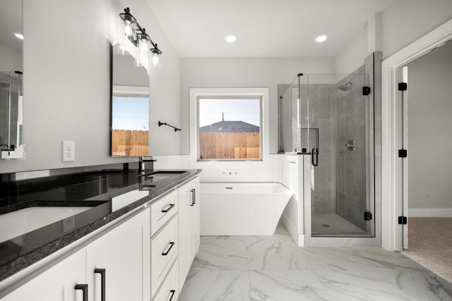7814 96th St, Lubbock, TX 79424 - full bathroom with double vanity, a stall shower, a freestanding tub, recessed lighting, and marble finish floors