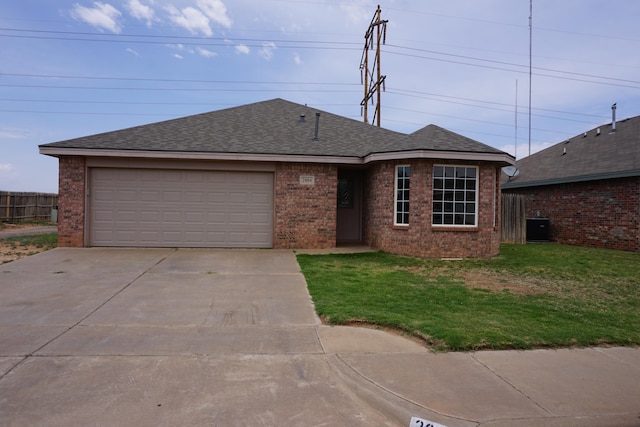 single story home with a garage and a front lawn