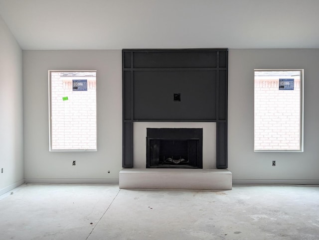 unfurnished living room with a fireplace and plenty of natural light