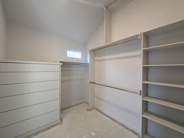 walk in closet with lofted ceiling