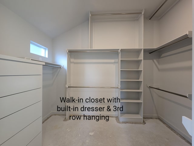 walk in closet featuring vaulted ceiling