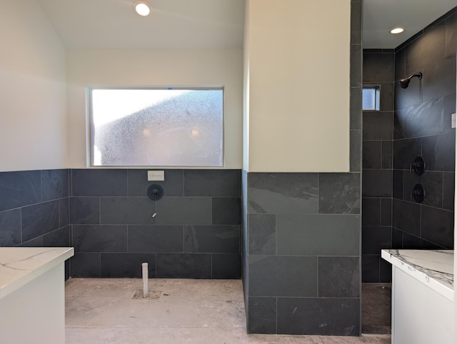 bathroom with a walk in shower and tile walls