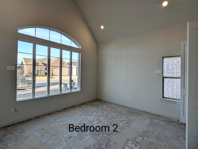 unfurnished room with high vaulted ceiling, recessed lighting, a residential view, and baseboards