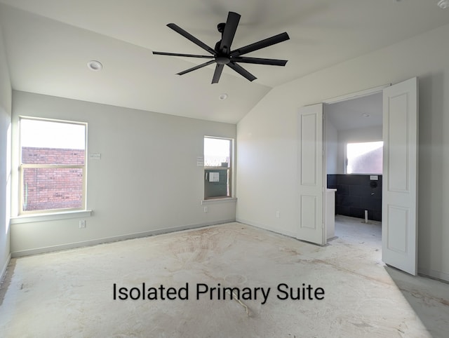 spare room with lofted ceiling, a ceiling fan, concrete flooring, and baseboards