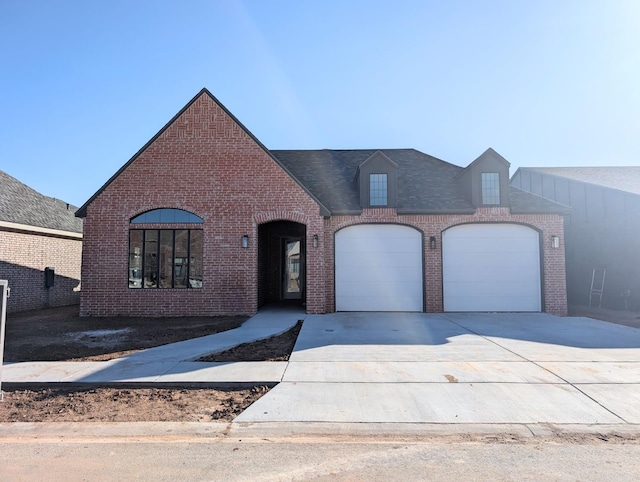 french country home featuring a garage