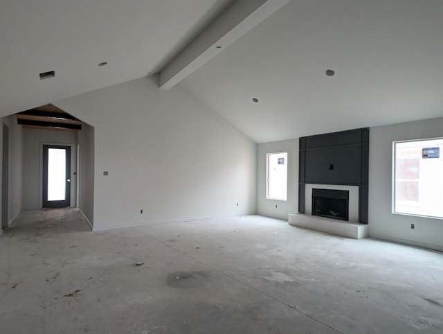 unfurnished living room featuring a fireplace and lofted ceiling with beams