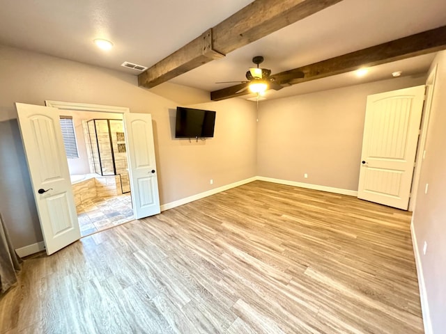 spare room featuring ceiling fan, visible vents, baseboards, beamed ceiling, and light wood-style floors