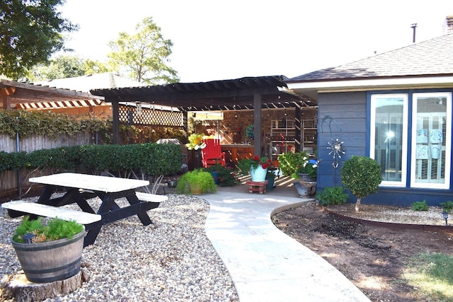 exterior space featuring fence and a pergola