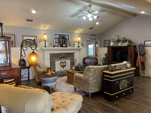 living room featuring hardwood / wood-style flooring, a fireplace, and lofted ceiling with beams