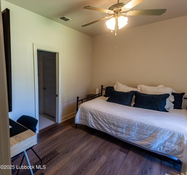 11707 Uxbridge Ave, Lubbock, TX 79424 - bedroom with wood finished floors, ceiling fan, and baseboards