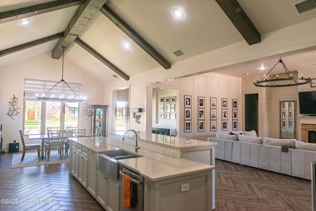 11707 Uxbridge Ave, Lubbock, TX 79424 - kitchen with a chandelier, a sink, open floor plan, beamed ceiling, and dishwashing machine