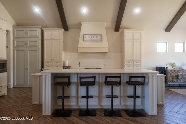 11707 Uxbridge Ave, Lubbock, TX 79424 - kitchen with light countertops, decorative backsplash, stainless steel microwave, a spacious island, and recessed lighting