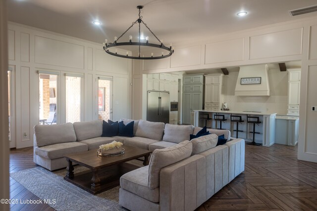11707 Uxbridge Ave, Lubbock, TX 79424 - living room featuring a decorative wall, a chandelier, and recessed lighting