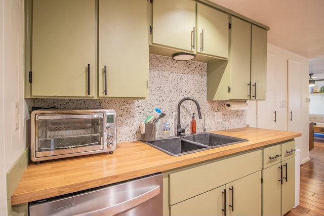 kitchen featuring a toaster, a sink, decorative backsplash, wood counters, and dishwasher