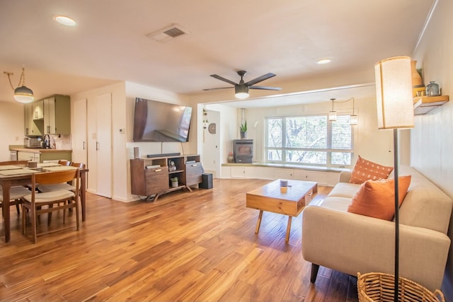 living area featuring recessed lighting, visible vents, ceiling fan, and light wood-style floors