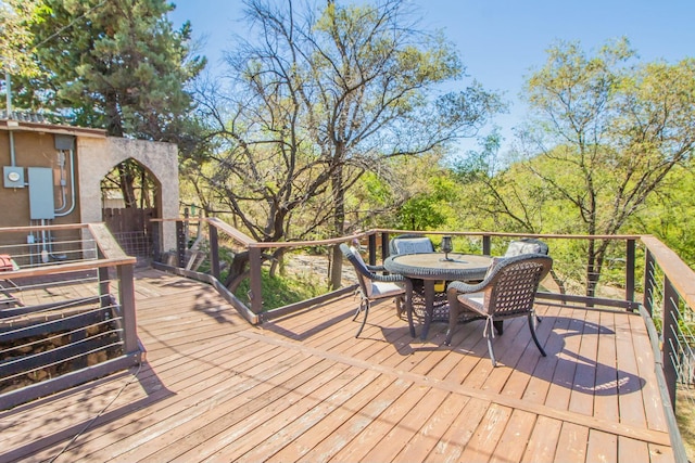 wooden terrace with outdoor dining area