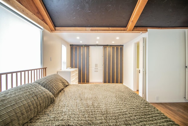 bedroom featuring recessed lighting, beamed ceiling, and wood finished floors