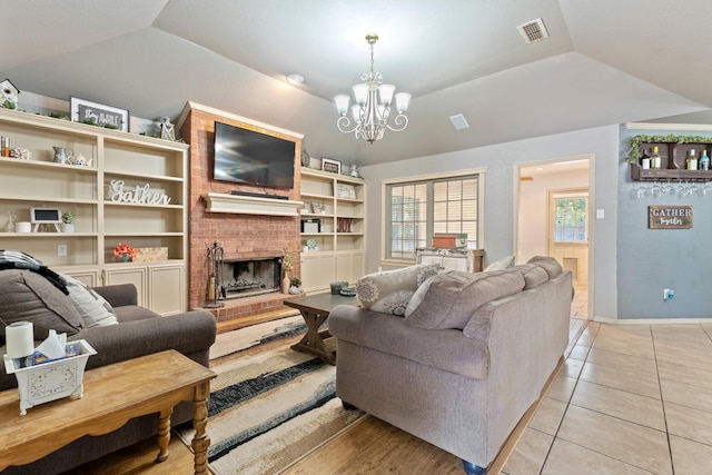 tiled living room featuring a tray ceiling, a chandelier, vaulted ceiling, and a brick fireplace