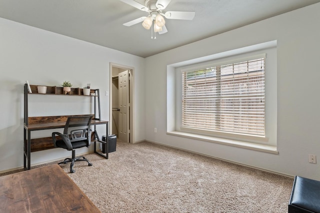 carpeted home office with ceiling fan