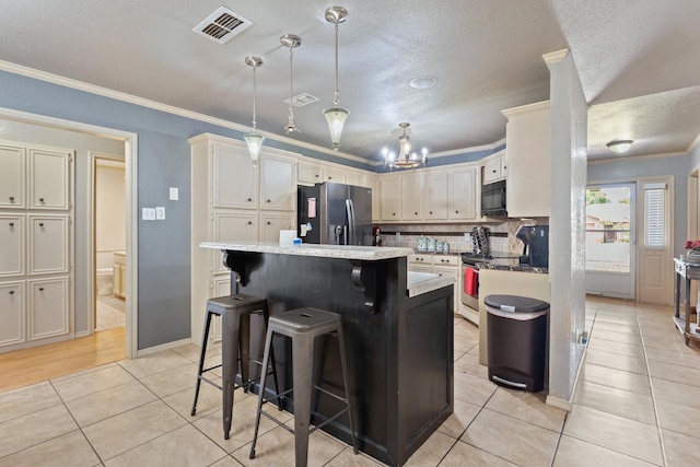 kitchen featuring a center island, stainless steel fridge with ice dispenser, a kitchen breakfast bar, pendant lighting, and stove