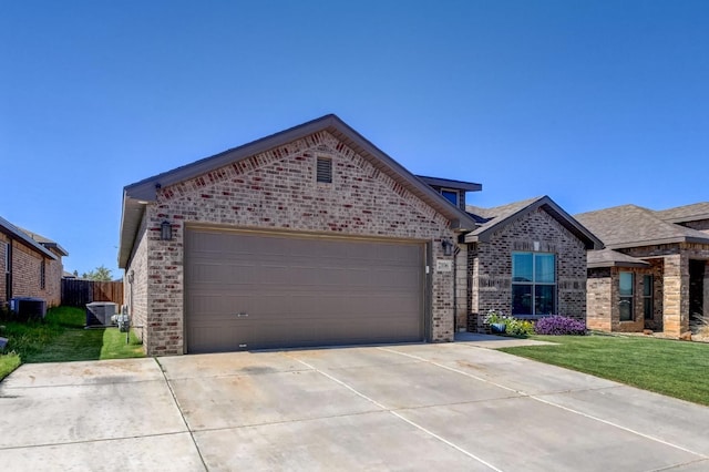 view of front facade with central AC unit, a garage, and a front lawn