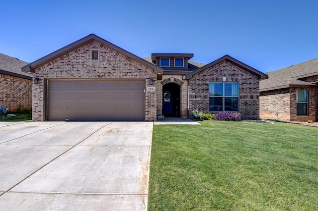 view of front of house featuring a garage and a front lawn