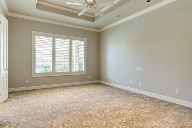 carpeted empty room featuring crown molding, a raised ceiling, and ceiling fan