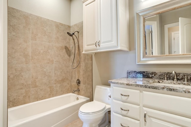 full bathroom with tiled shower / bath, vanity, and toilet