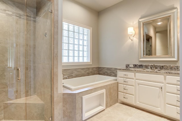 bathroom with independent shower and bath, vanity, and tile patterned flooring