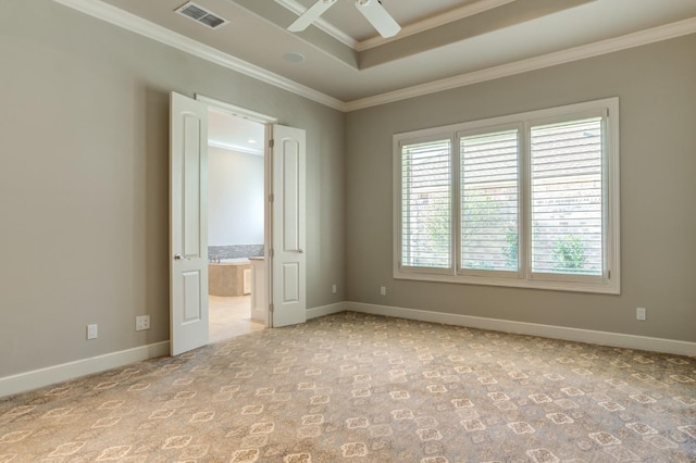 carpeted empty room with crown molding, ceiling fan, and a tray ceiling