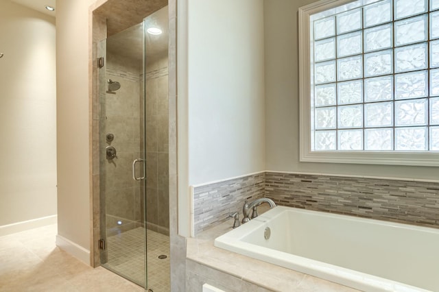 bathroom featuring tile patterned floors and shower with separate bathtub