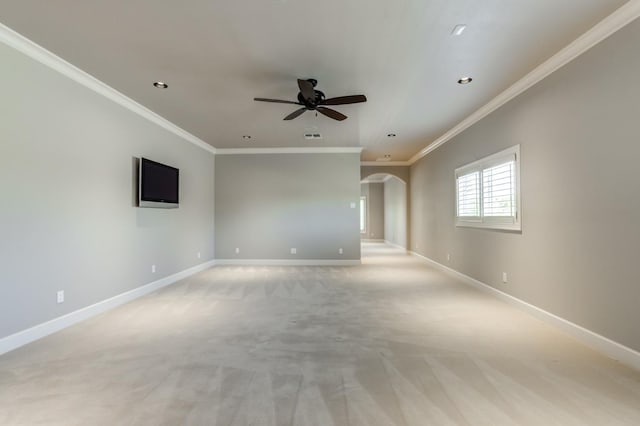 spare room with crown molding, light colored carpet, and ceiling fan