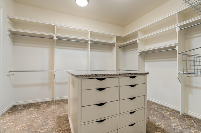 spacious closet featuring dark carpet