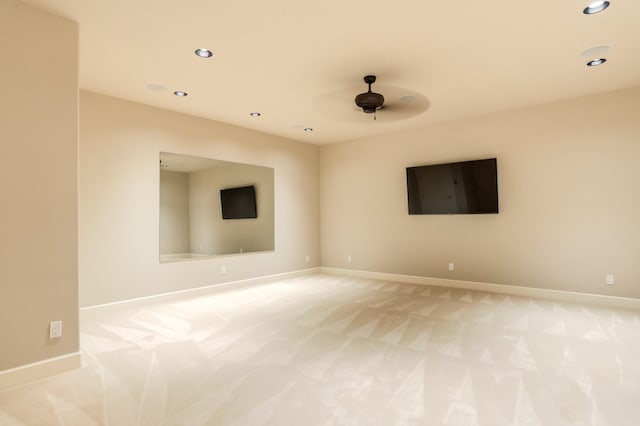 spare room featuring light carpet and ceiling fan