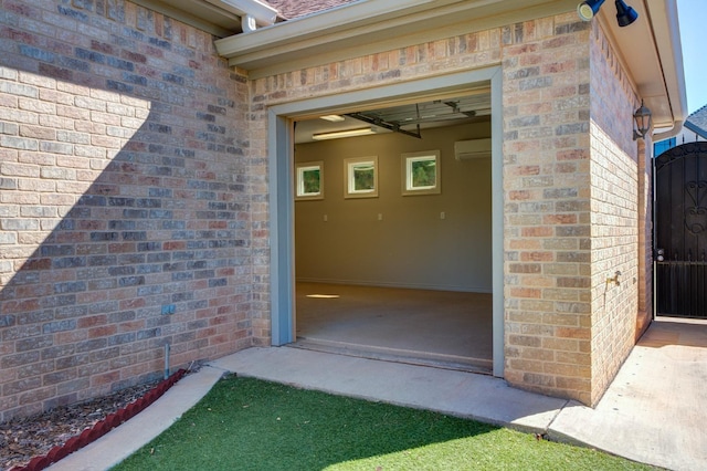 view of exterior entry with an AC wall unit