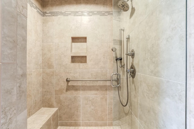 bathroom with a shower with door