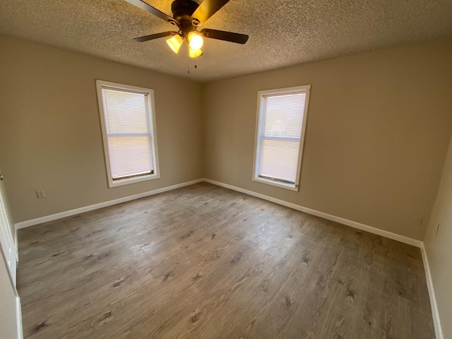 spare room with ceiling fan, hardwood / wood-style flooring, and a textured ceiling