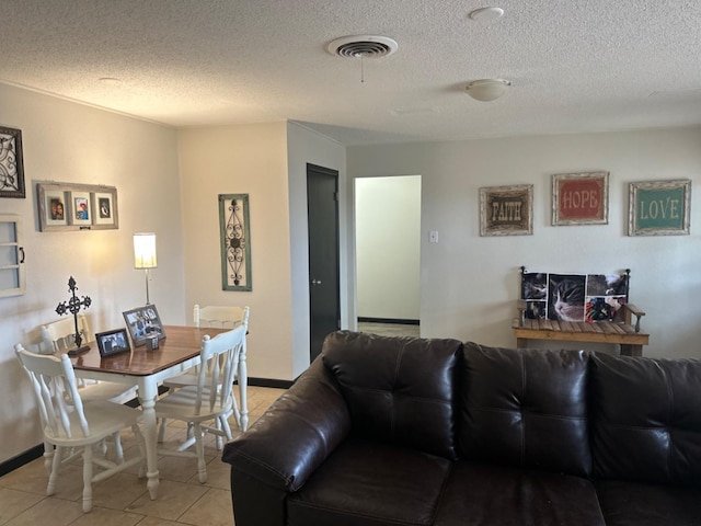 tiled living room featuring a textured ceiling