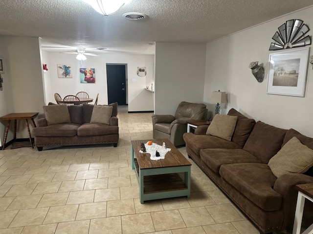 living room with light tile patterned flooring and a textured ceiling