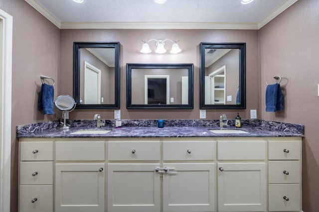 bathroom with crown molding, vanity, and a textured ceiling