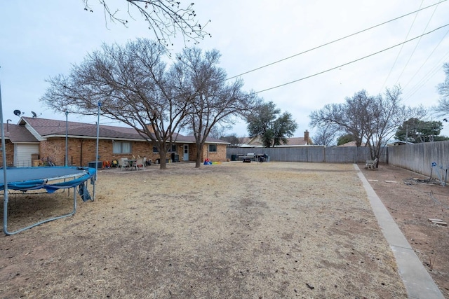 view of yard featuring a trampoline