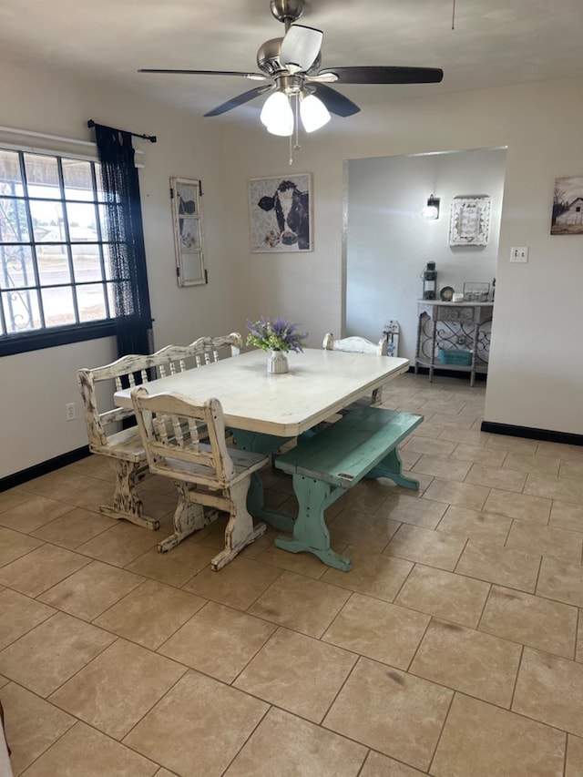 dining area with light tile patterned floors and ceiling fan